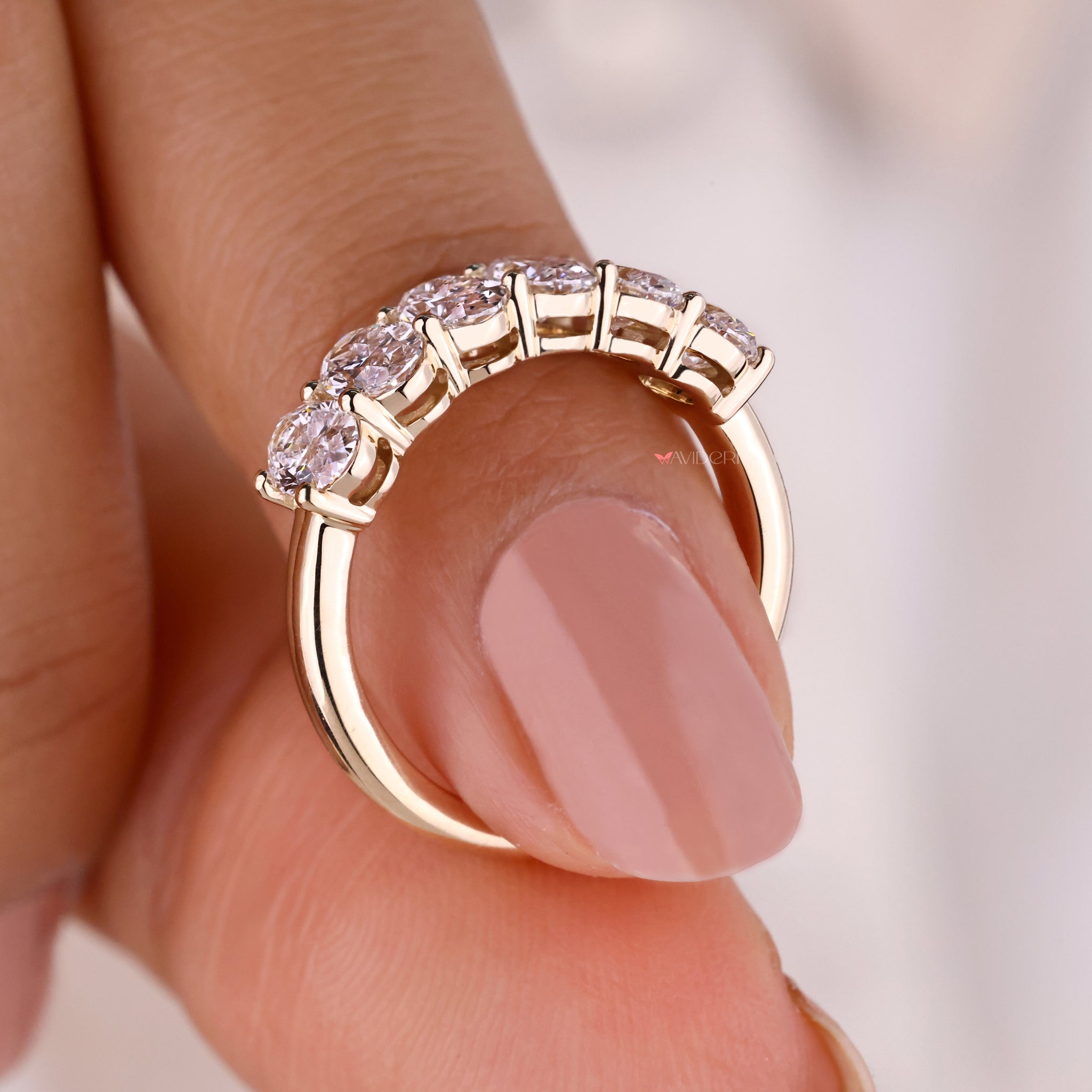 Yellow gold band featuring lab grown diamonds.
