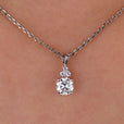 Round cut moissanite pendant set in white gold.
