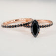 Marquise moissanite ring featuring a stunning round cut center stone for a timeless design.