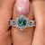 Halo cluster ring has small stones around the center for extra sparkle.