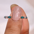 The cyan blue moissanite wedding band offers a bold pop of color.