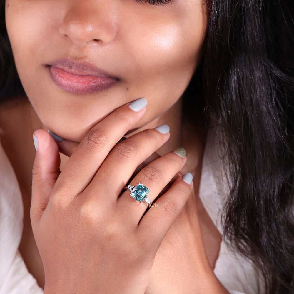 Emerald cut tapered baguettes engagement ring with unique side stones.
