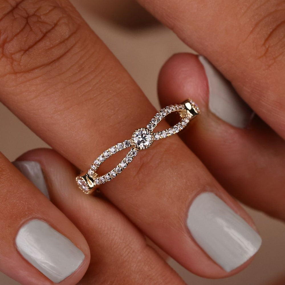 Round infinity band features endless sparkle with a continuous loop of radiant stones.
