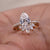 Pear engagement ring with wedding band in elegant design.
