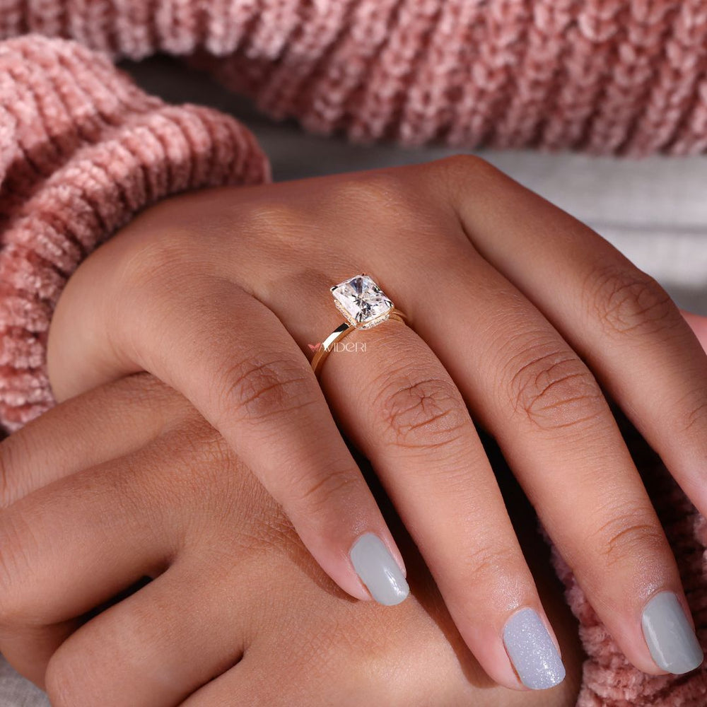 Moissanite radiant cut ring set in an elegant gold band.
