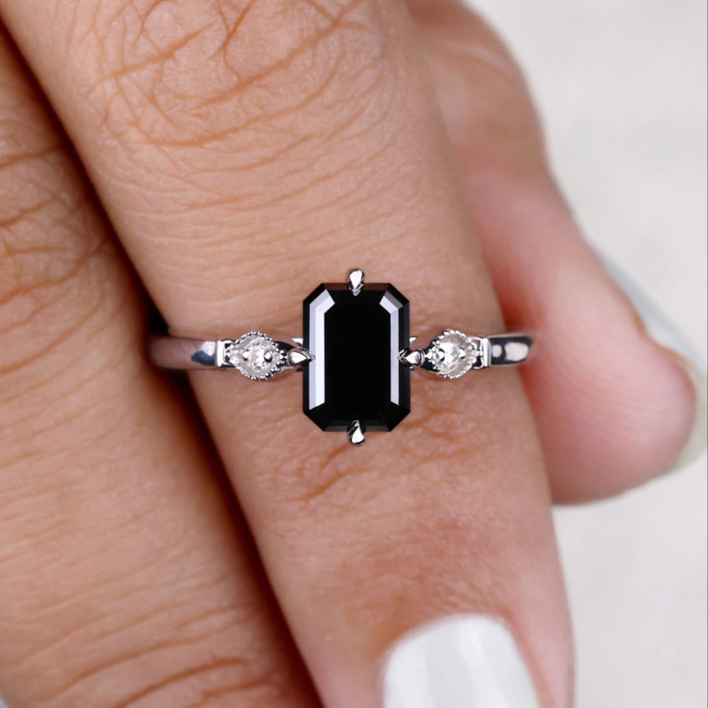 Cathedral setting ring with an emerald cut engagement ring for a bold look.
