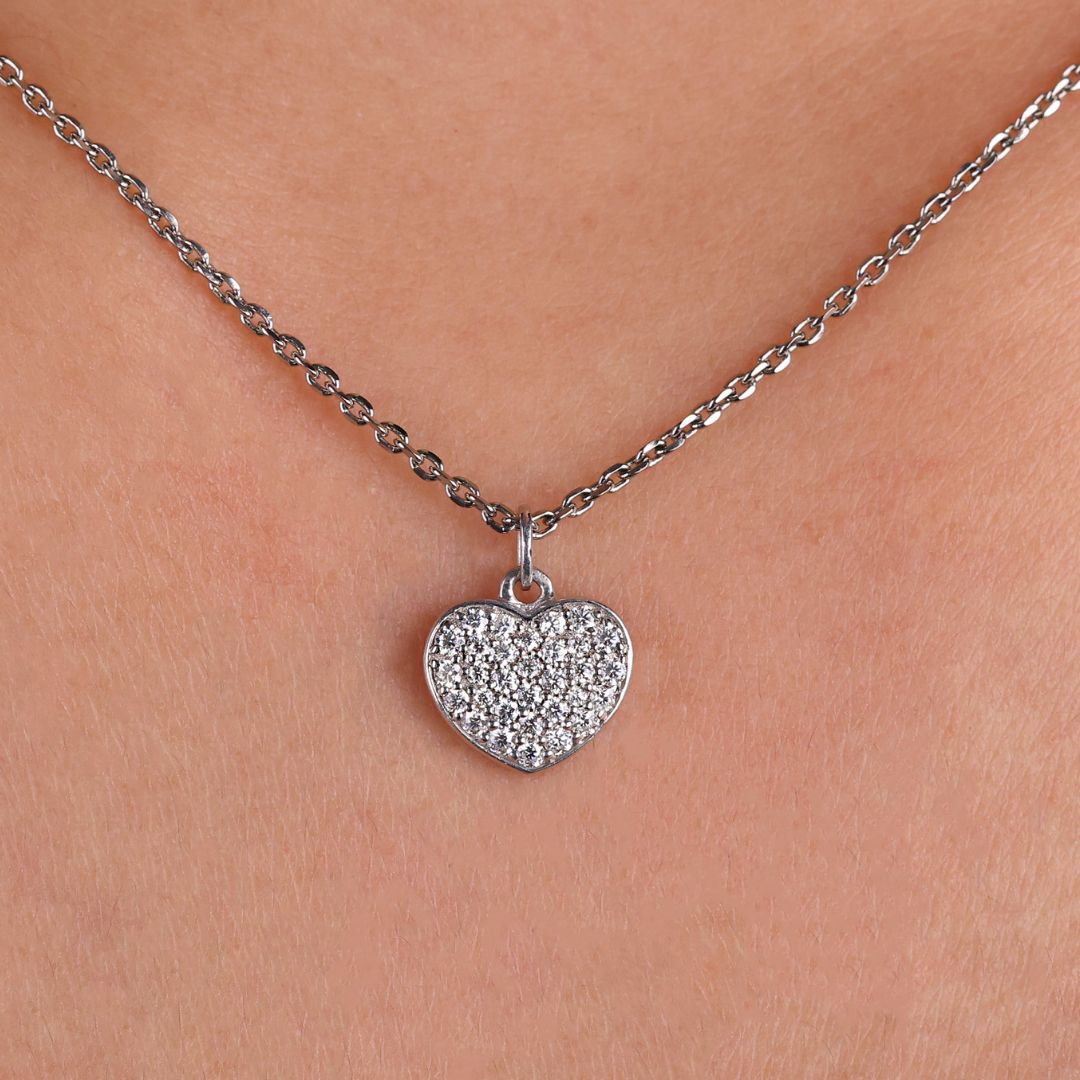 Heart shape pendant with a round moissanite cut stone.
