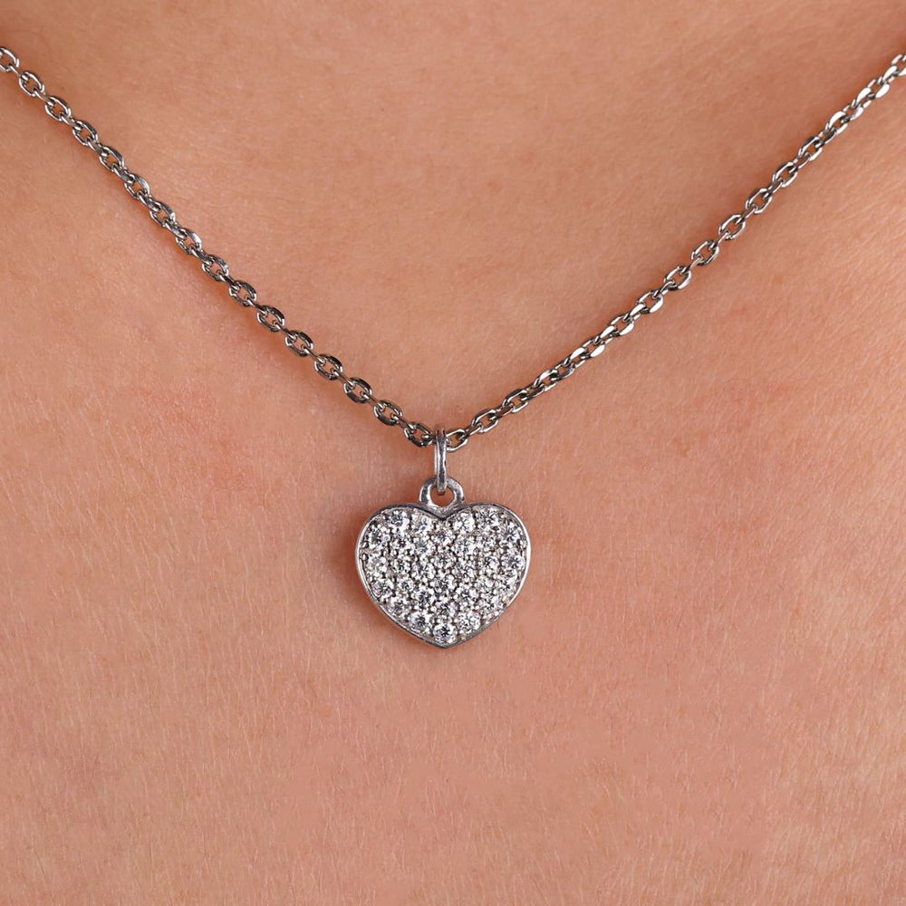 Heart shape pendant with a round moissanite cut stone.
