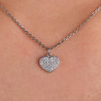 Heart shape pendant with a round moissanite cut stone.
