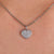 Heart shape pendant with a round moissanite cut stone.
