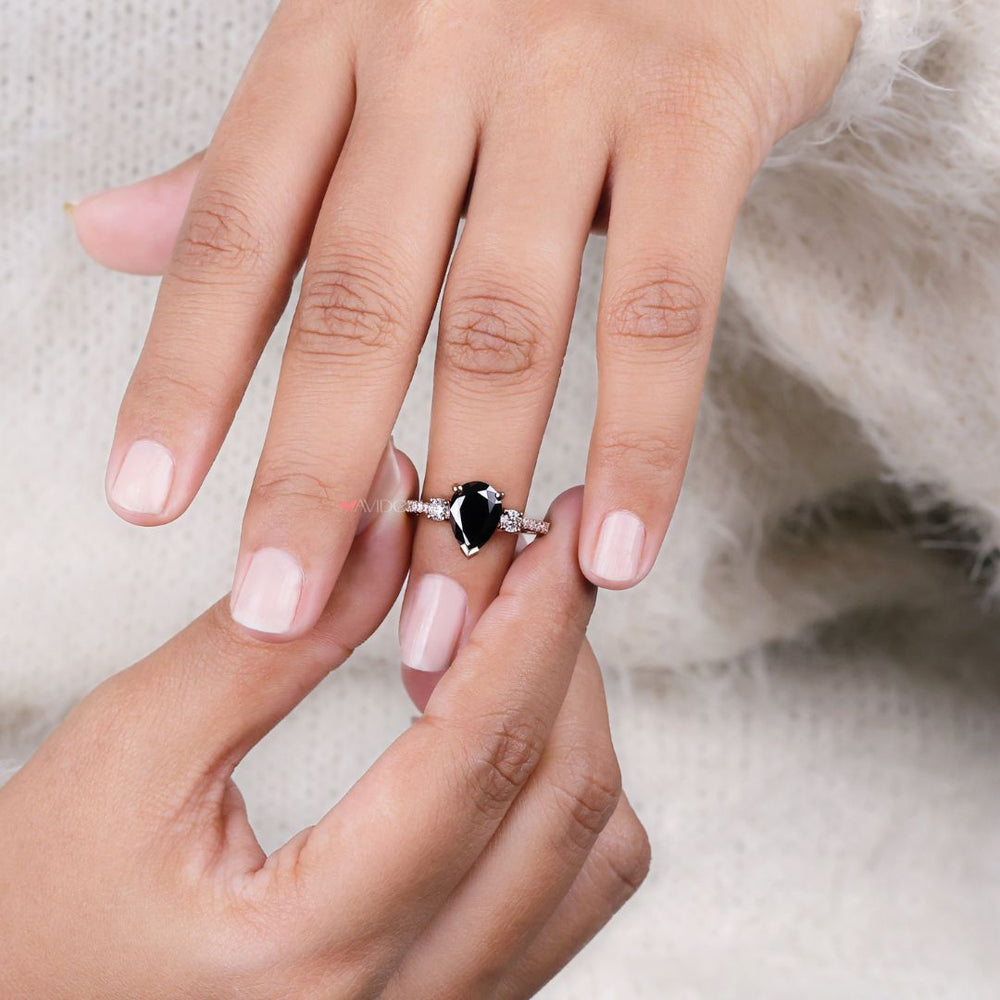 Pear shaped engagement ring featuring a beautiful rose gold setting
