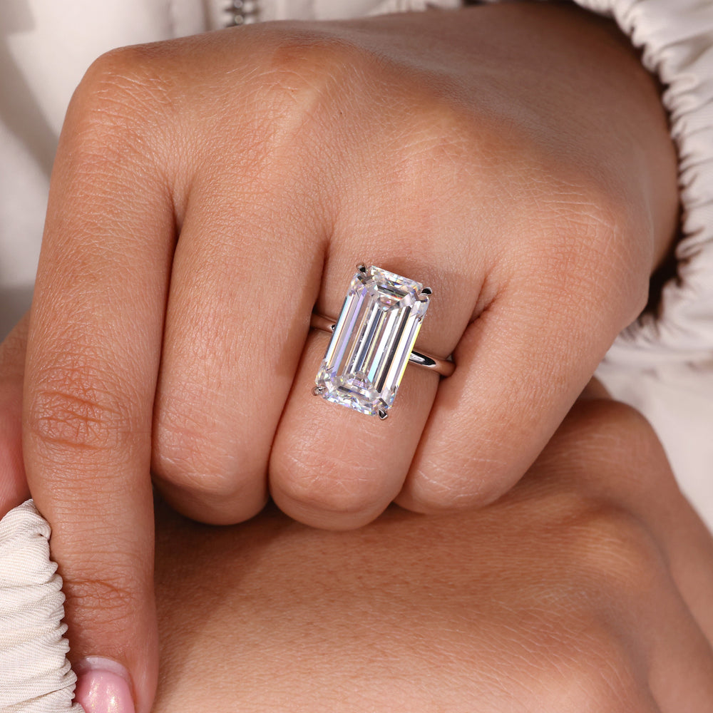Elongated emerald cut engagement ring with solitaire design.
