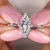 Marquise diamond ring featuring a sleek prong setting.