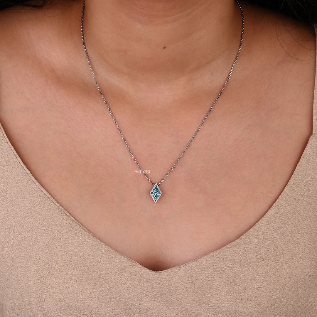 Handmade pendant with a lozenge cut moissanite stone in a halo setting.

