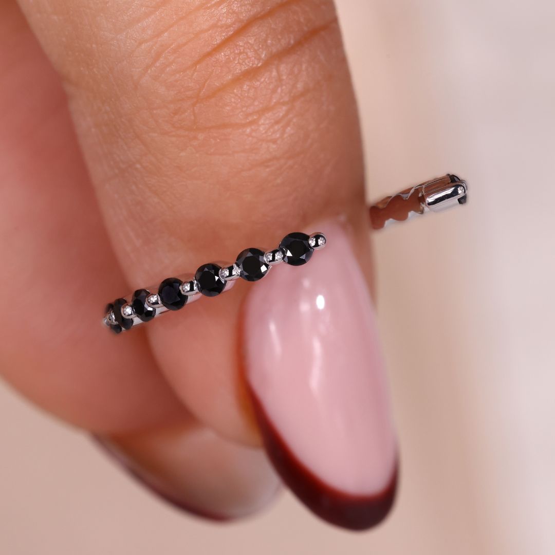 The shared prong band enhances brilliance with closely set stones.