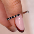 The shared prong band enhances brilliance with closely set stones.