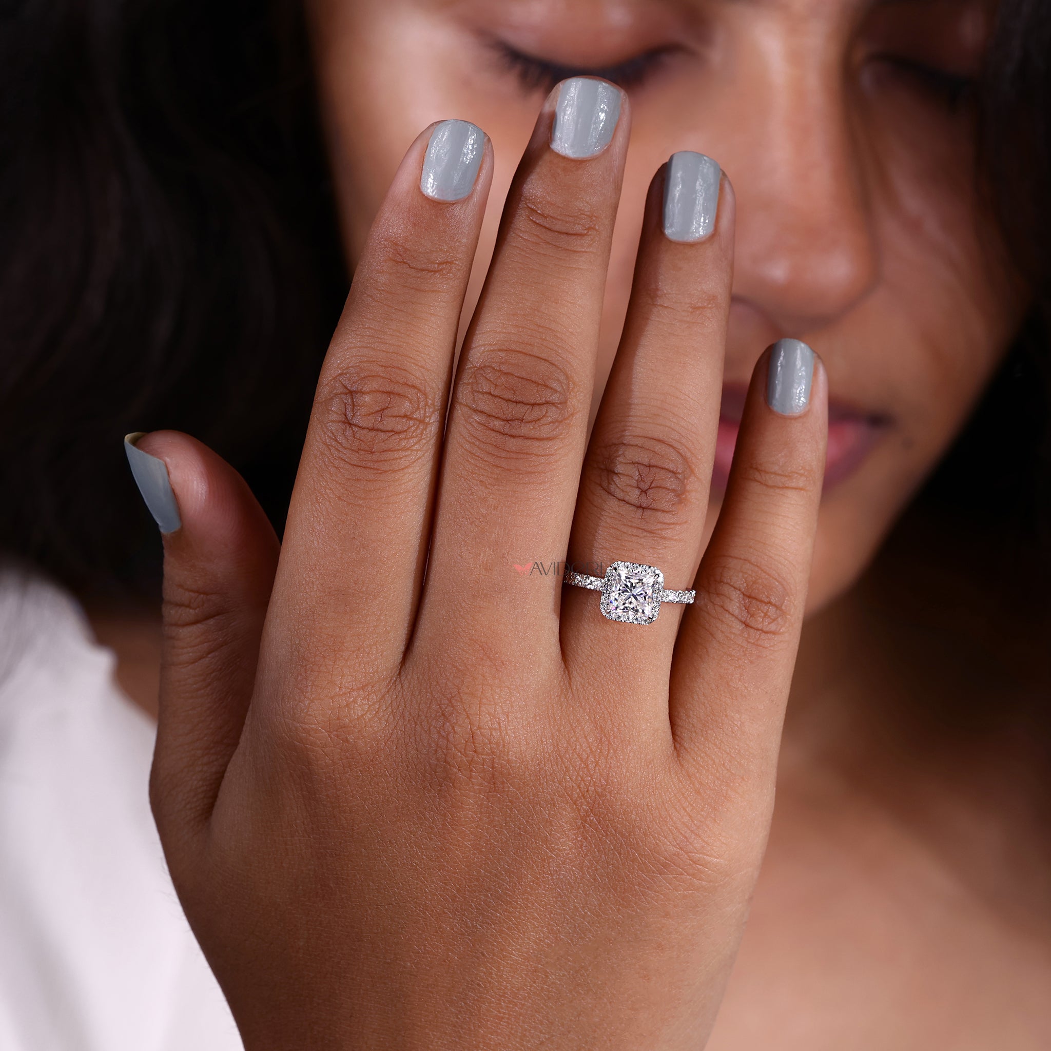 Pave setting moissanite ring with brilliant stone arrangement.
