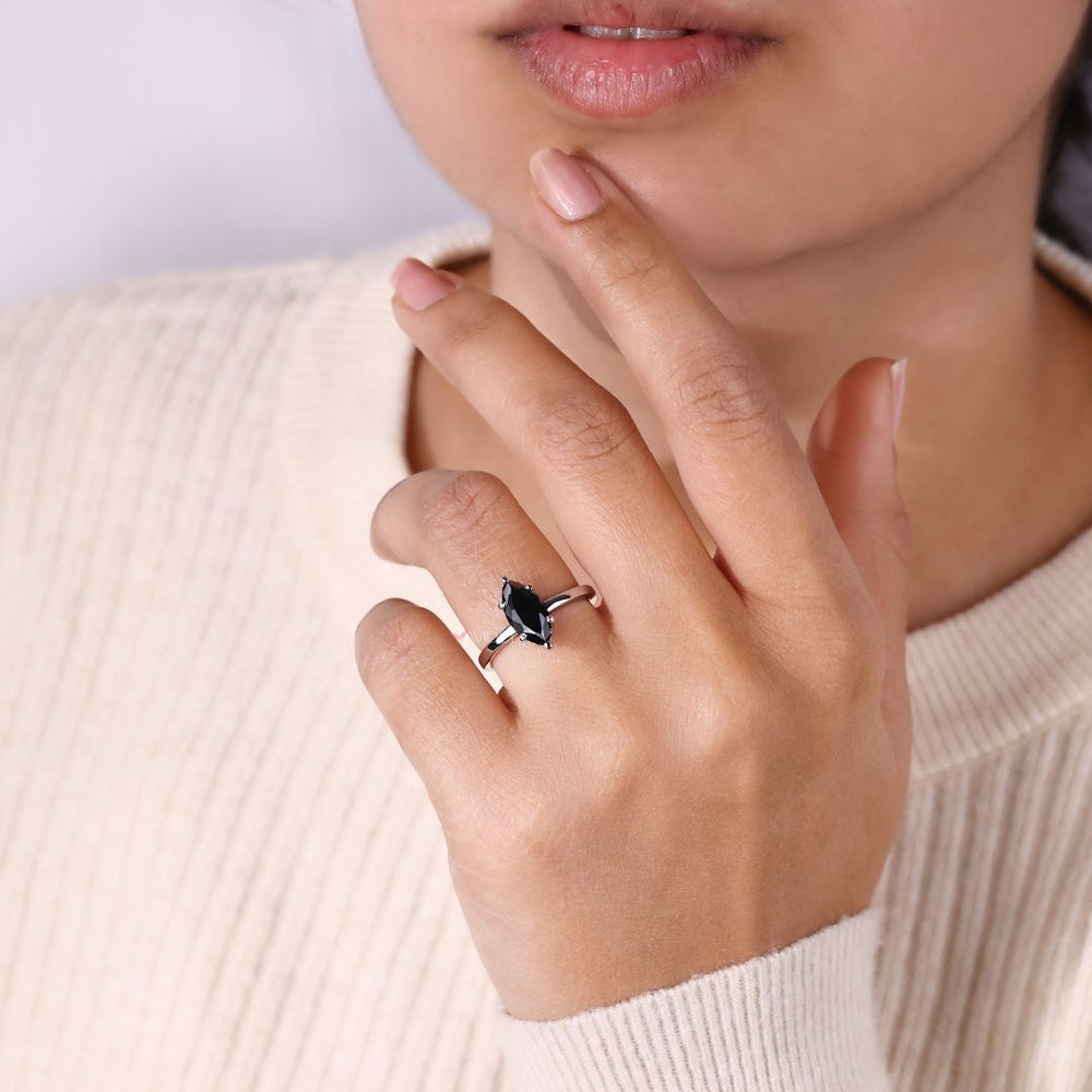 6 prong ring with a stunning marquise moissanite for added brilliance.
