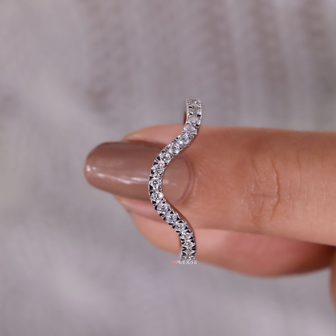 The curvy wedding band adds a smooth, modern touch.