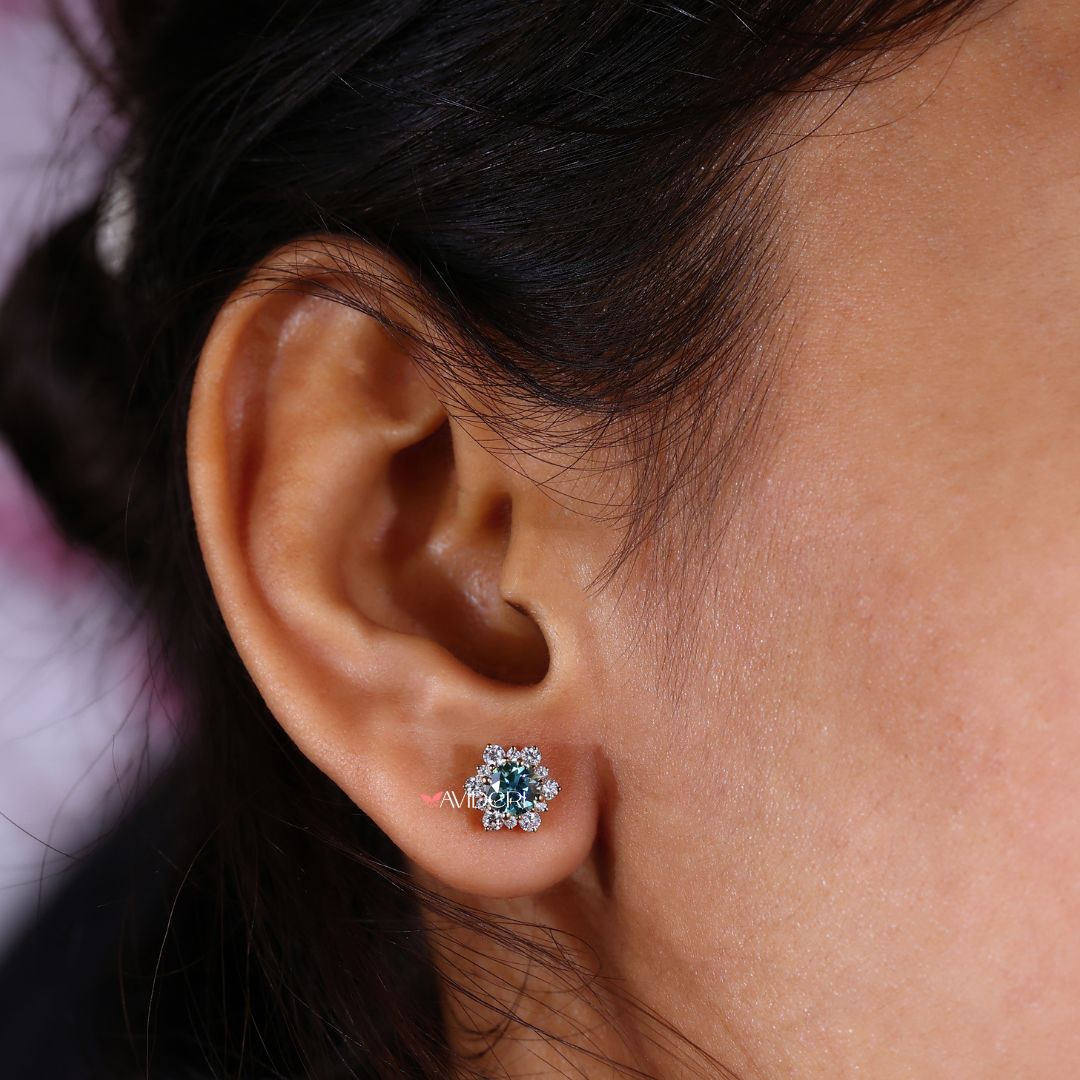 Round cut earrings in a halo cluster design set in yellow gold.