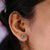 Round cut earrings in a halo cluster design set in yellow gold.