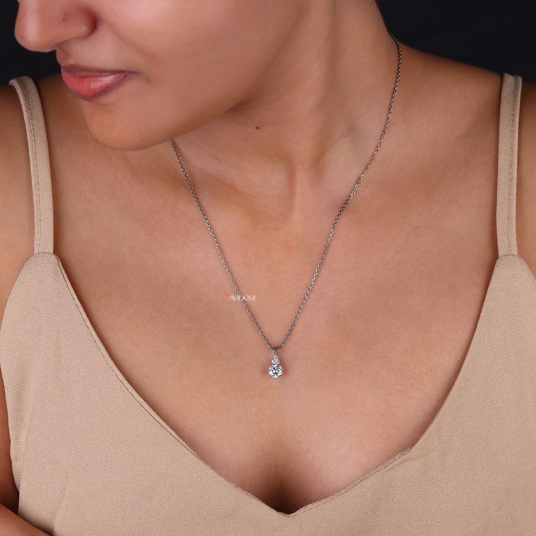 Bunny ear moissanite pendant with a round cut design.
