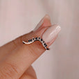 Black round cut Moissanite wedding band.