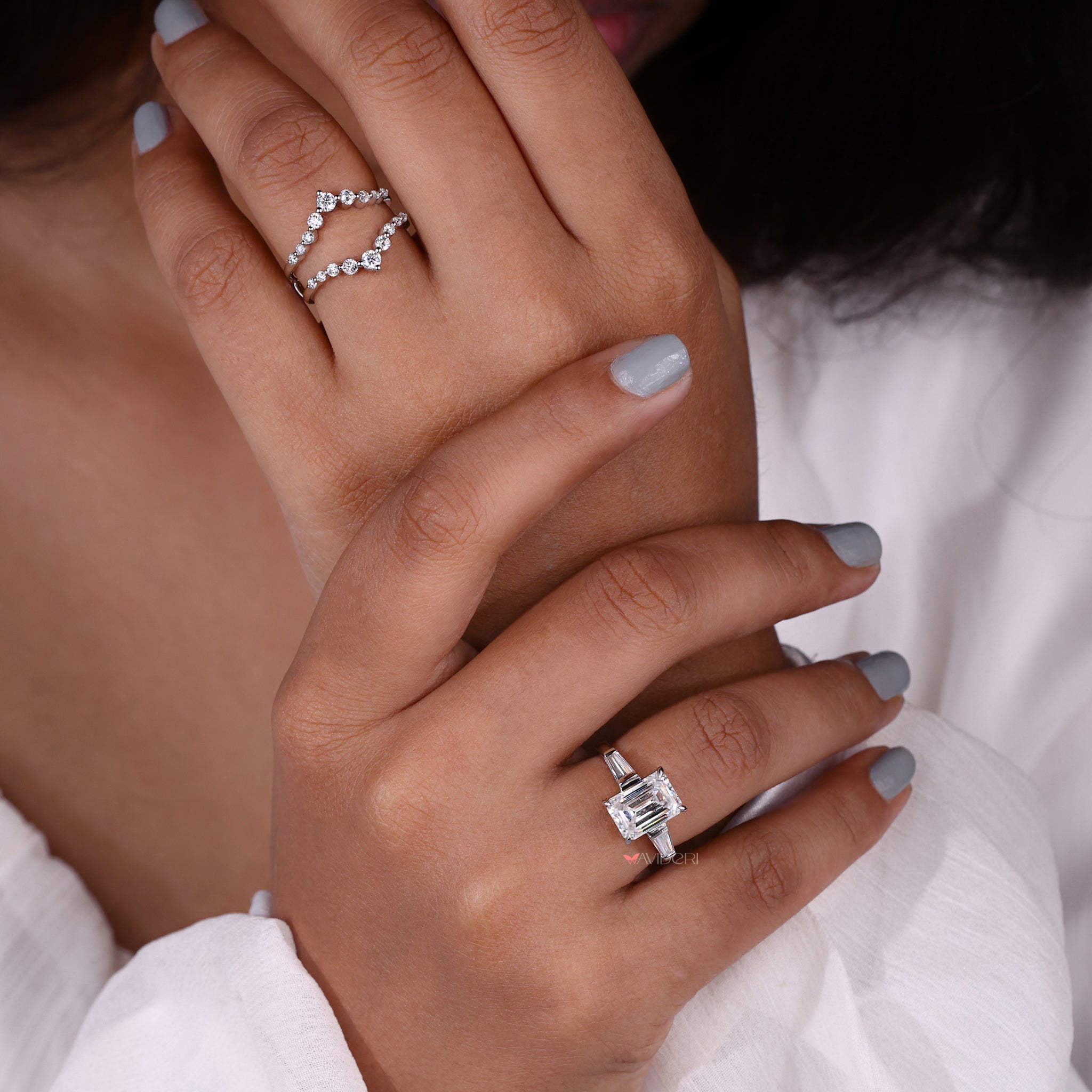 Emerald cut moissanite ring with classic design.