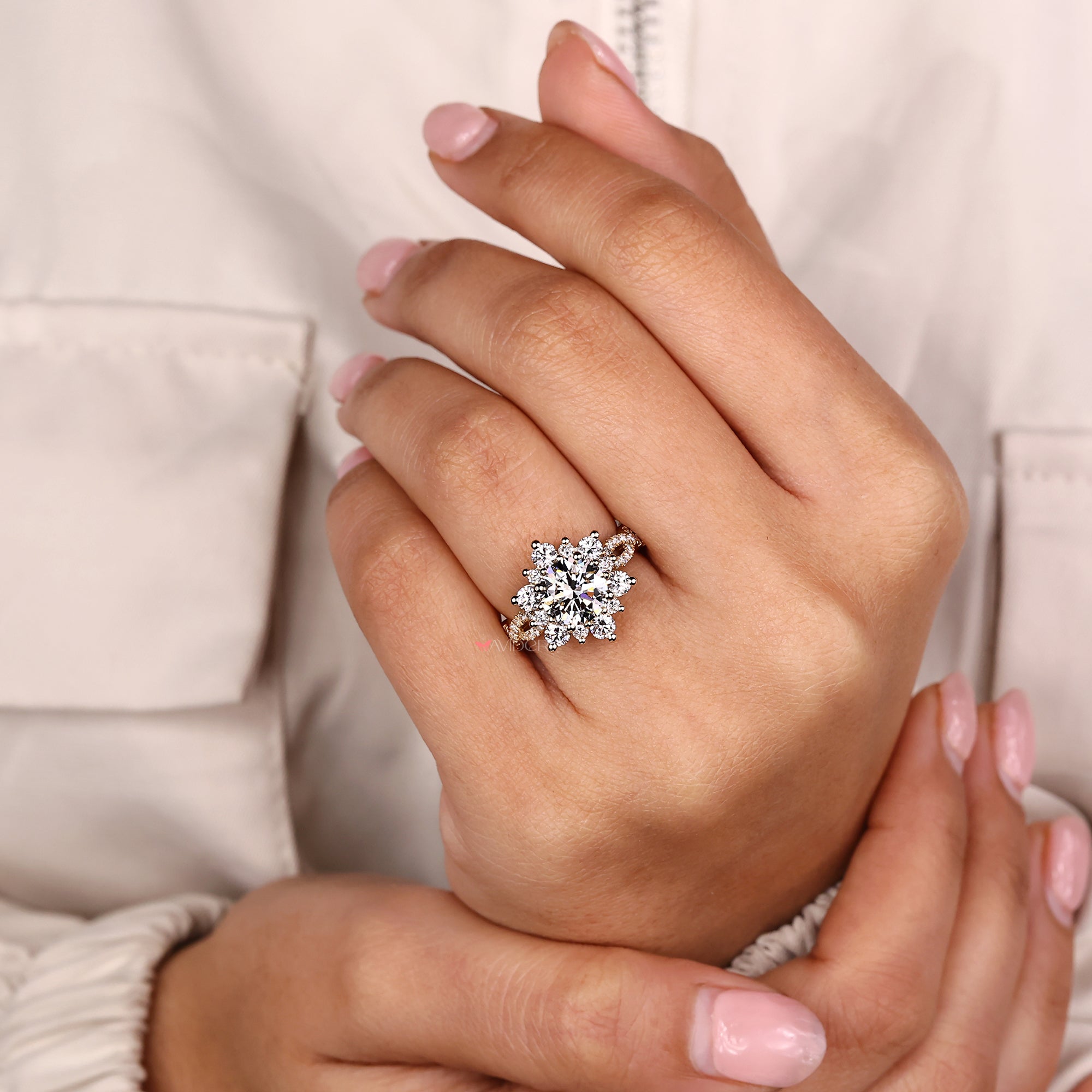 Close-up of a hand wearing a diamond ring with a soft background
