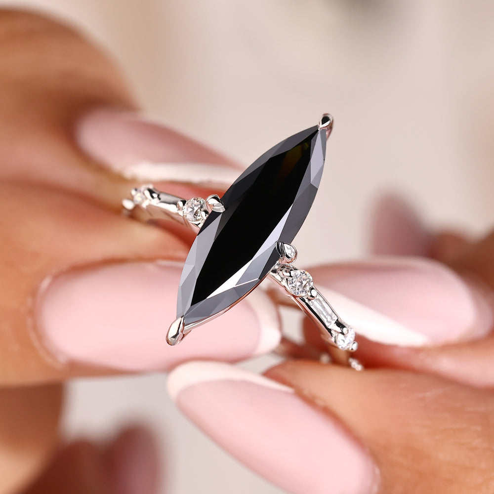 Long marquise cut ring with a distance pave setting.