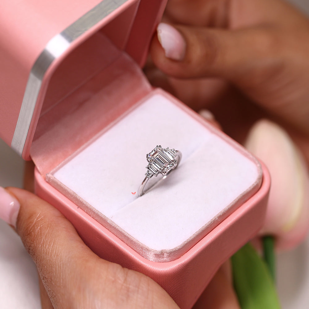 Emerald cut diamond ring with baguette side stones.
