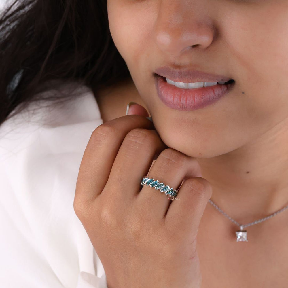 White gold band complements the brilliance of baguette and round stones with its bright finish.

