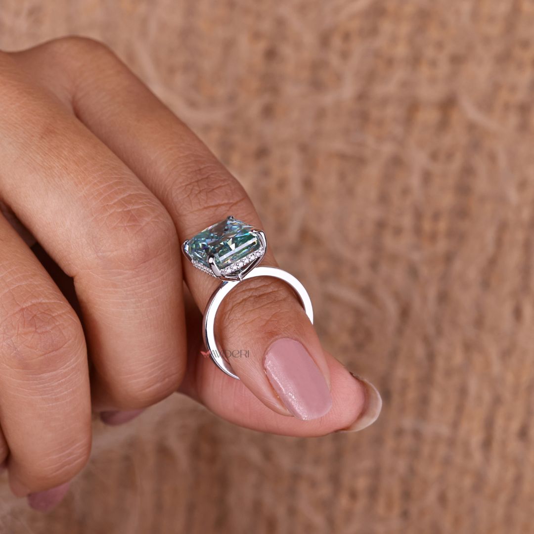 A hidden halo engagement ring adds depth beneath the center.
