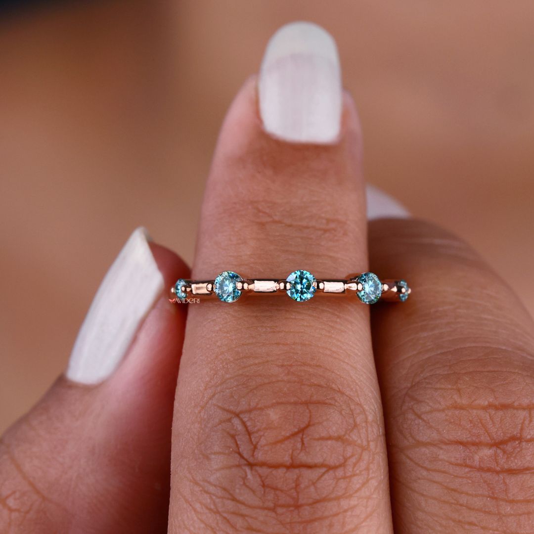 Cyan blue round wedding band features vibrant stones for a bold, modern look.
