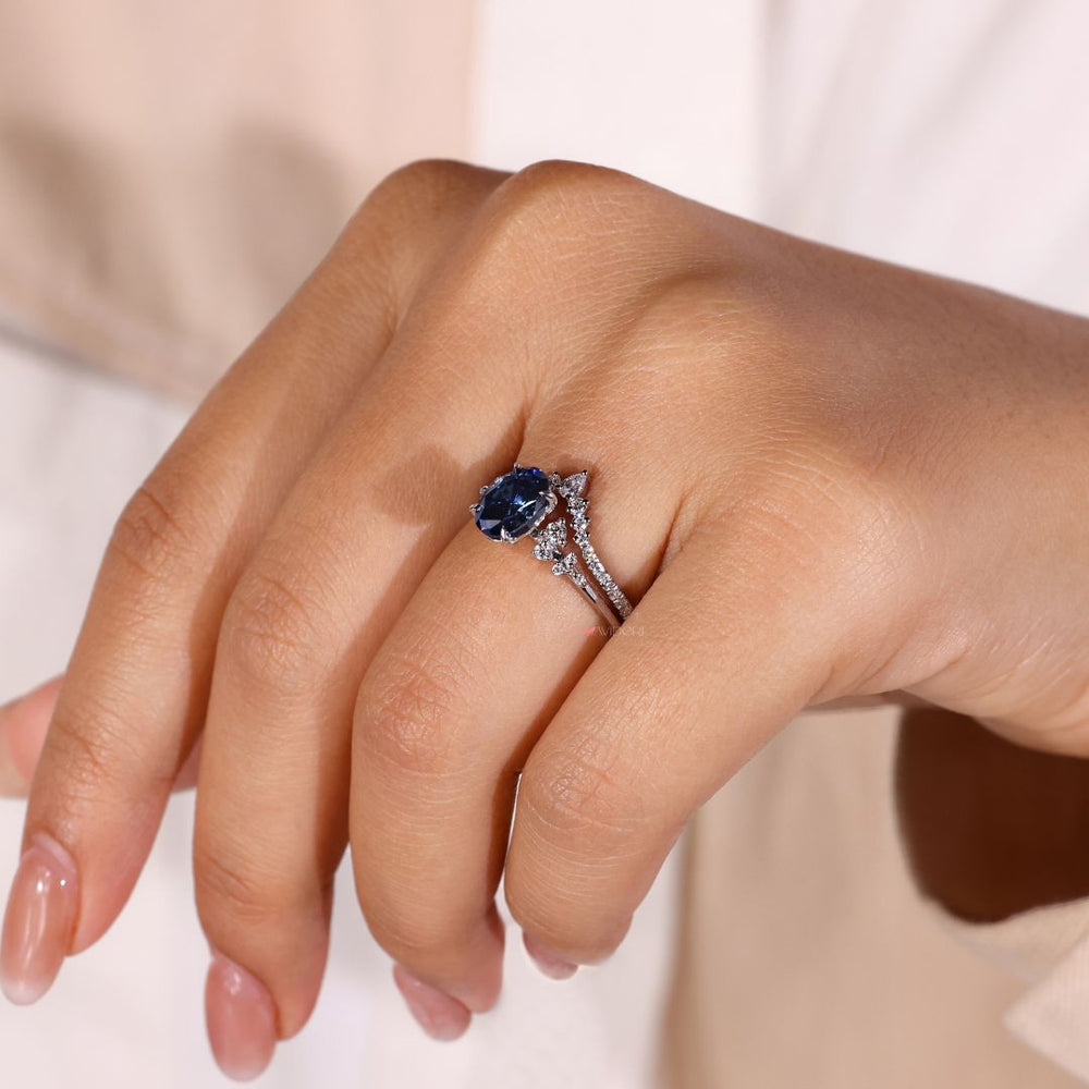 Chevron wedding band paired with an oval engagement ring for modern style.