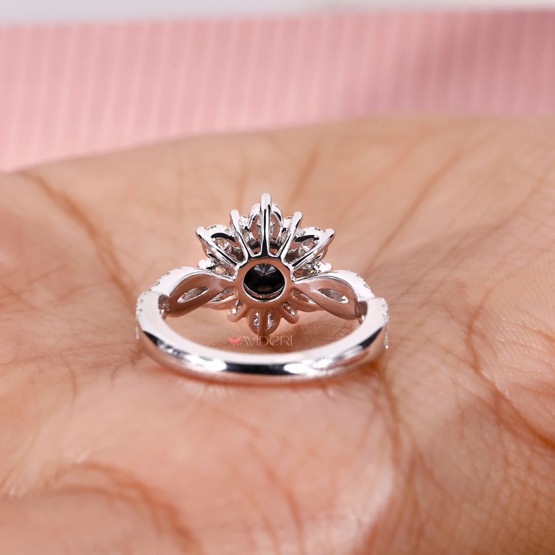 Infinity shank engagement ring featuring a round cut center stone.

