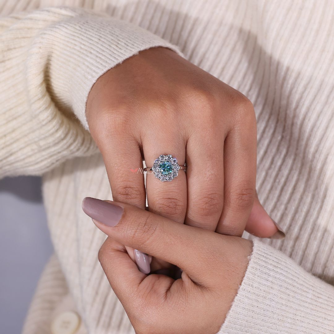 Cyan blue moissanite ring sparkles with a rare hue and deep clarity.
