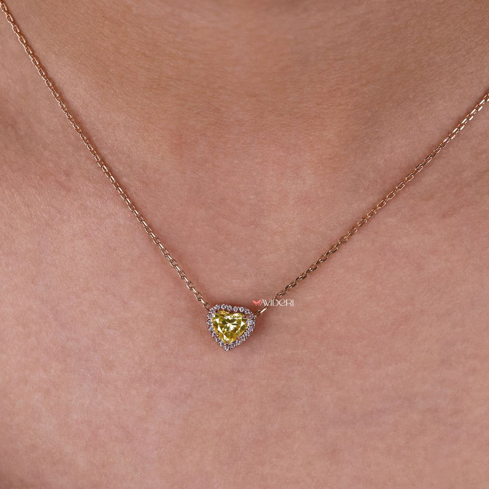 Customizable heart pendant with a moissanite halo setting.