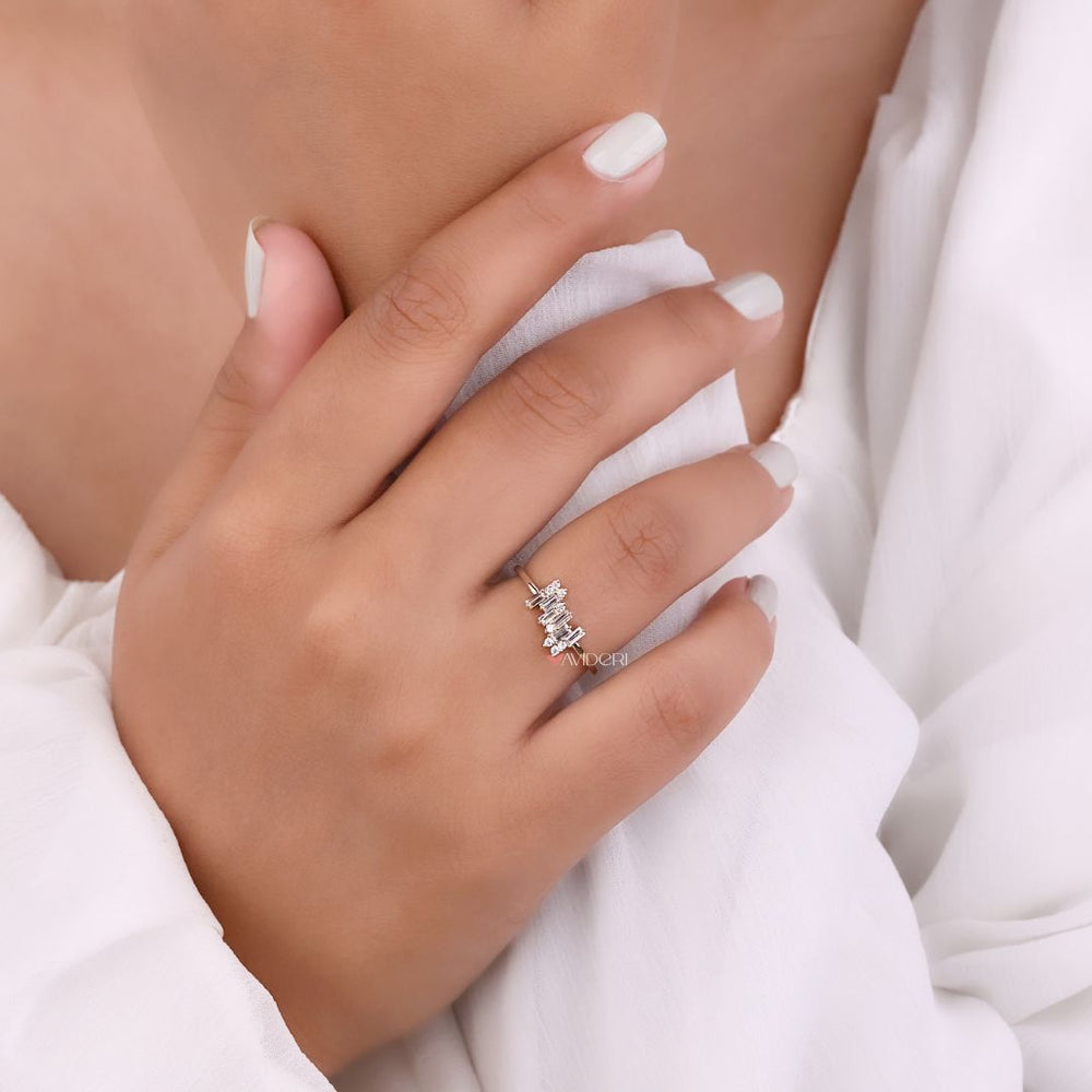 A handmade ring shown on a light wooden surface.
