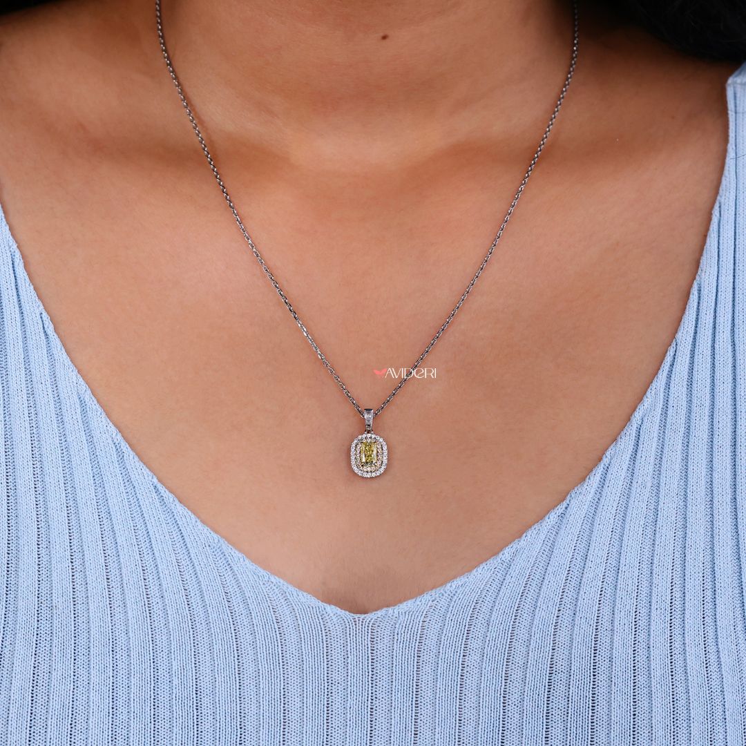 Radiant cut pendant with tapered baguette accents.