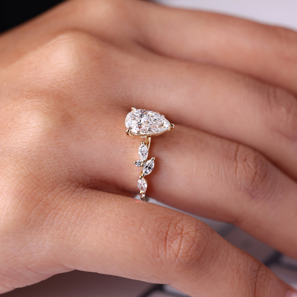 Nature inspired engagement ring with leaf-like curves and side diamond accents.
