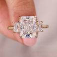 Three stone moissanite ring with radiant cut center.