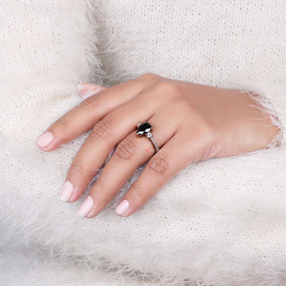 Rose gold engagement ring with a pear-shaped center stone
