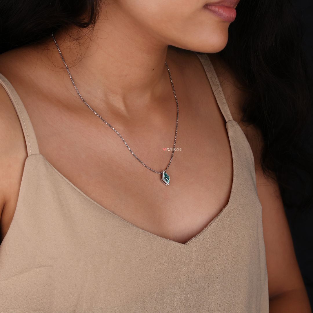 Customize pendant featuring a lozenge cut moissanite stone in white gold.

