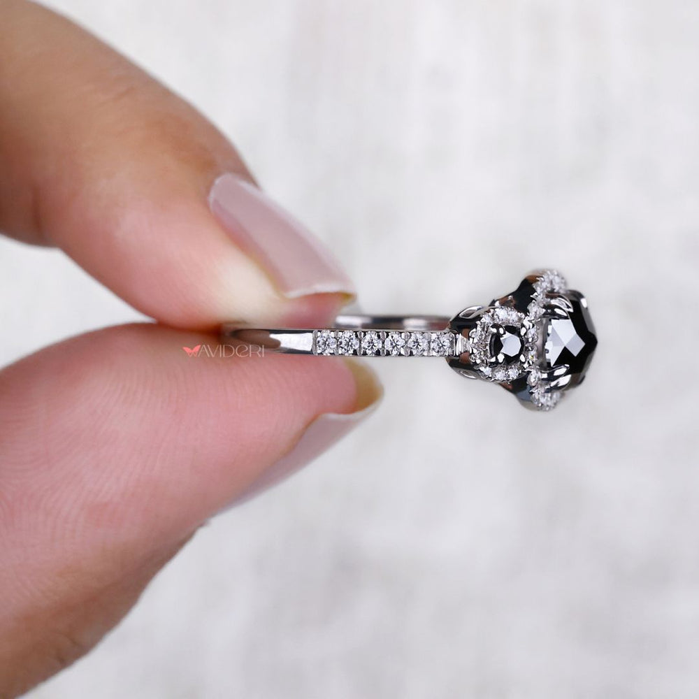 Three stone ring design featuring a cushion cut moissanite centerpiece.
