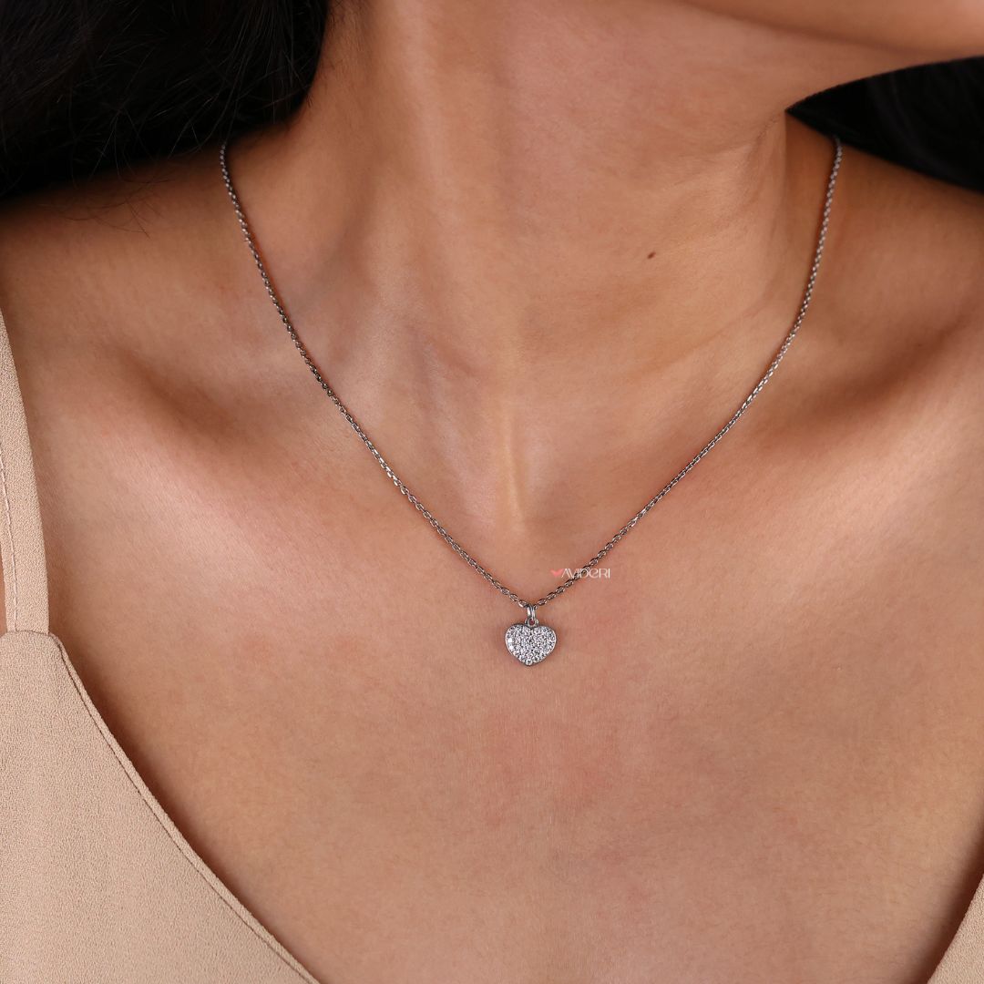 Handmade pendant featuring a heart shape and round moissanite cut stone.
