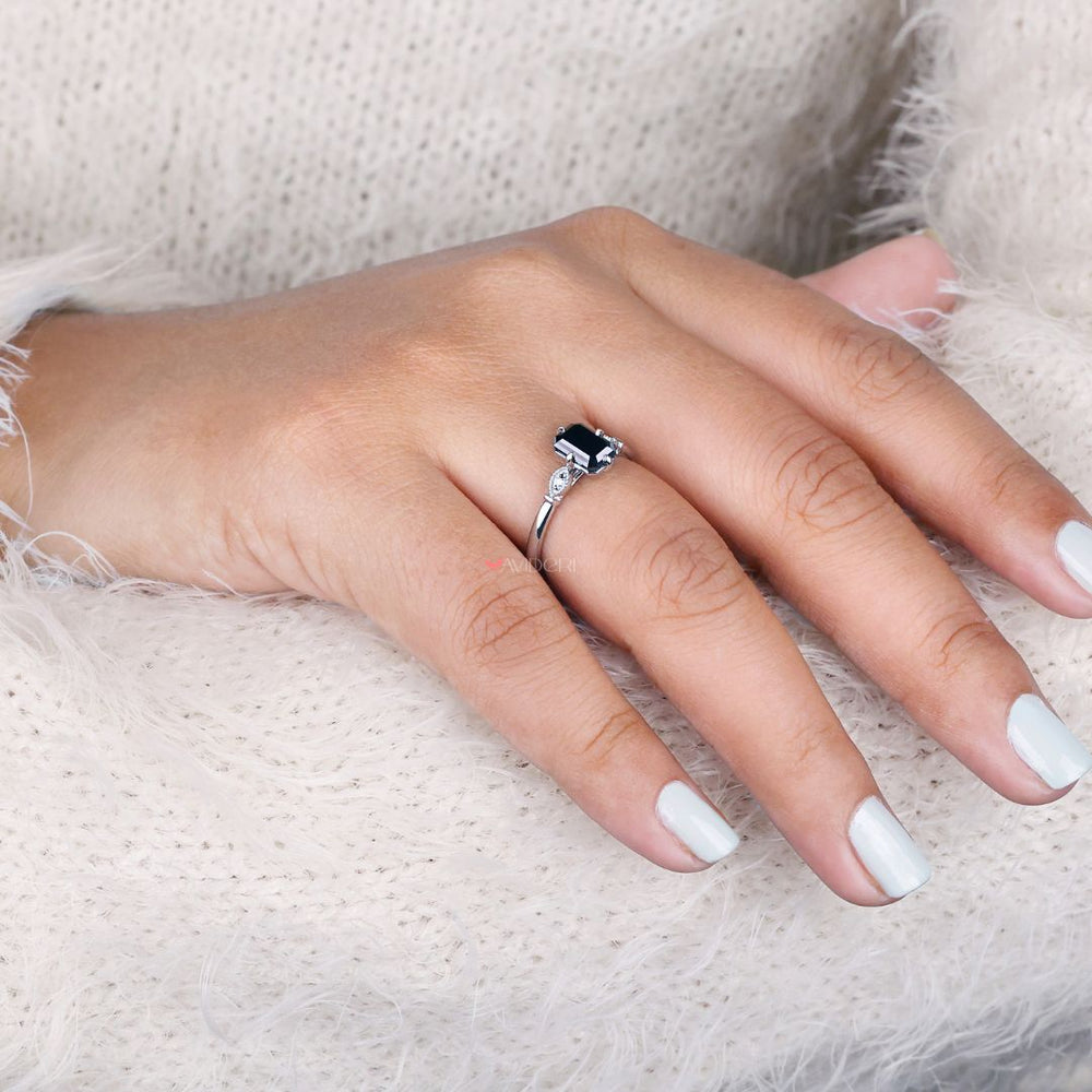Elegant emerald cut engagement ring set in a cathedral setting ring.
