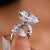 Pear-shaped engagement ring with a hidden halo.
