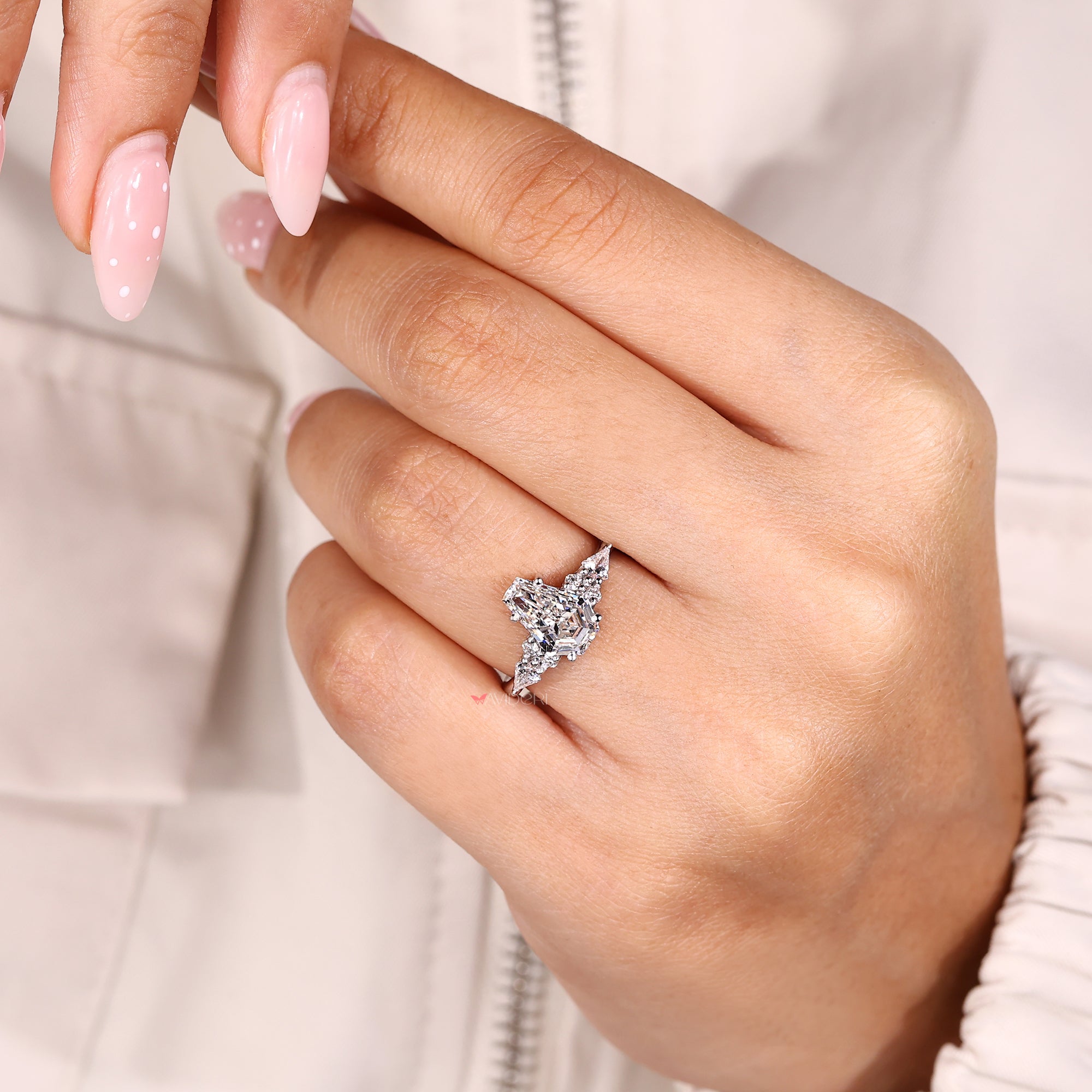 Coffin cut engagement ring with muse setting and kite sides.