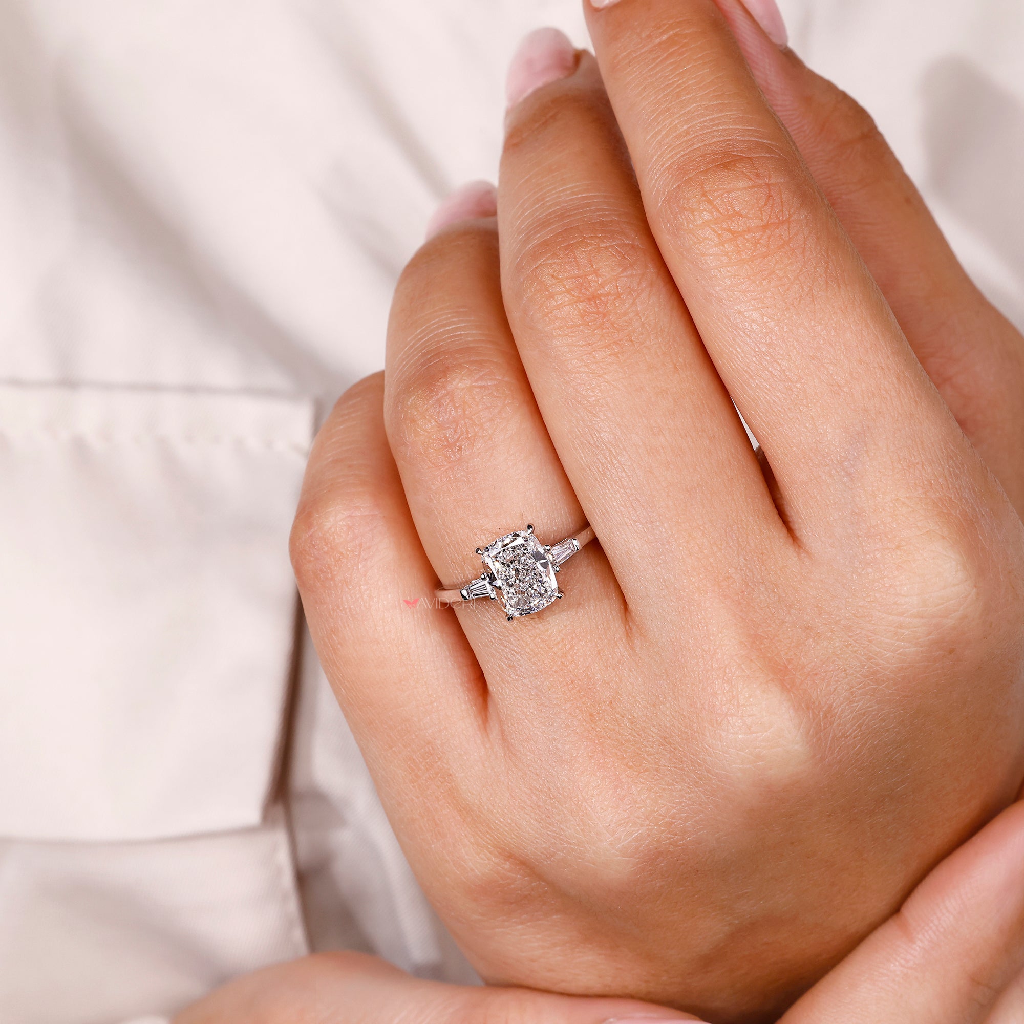 Cushion cut engagement ring with tapered baguette side stones.